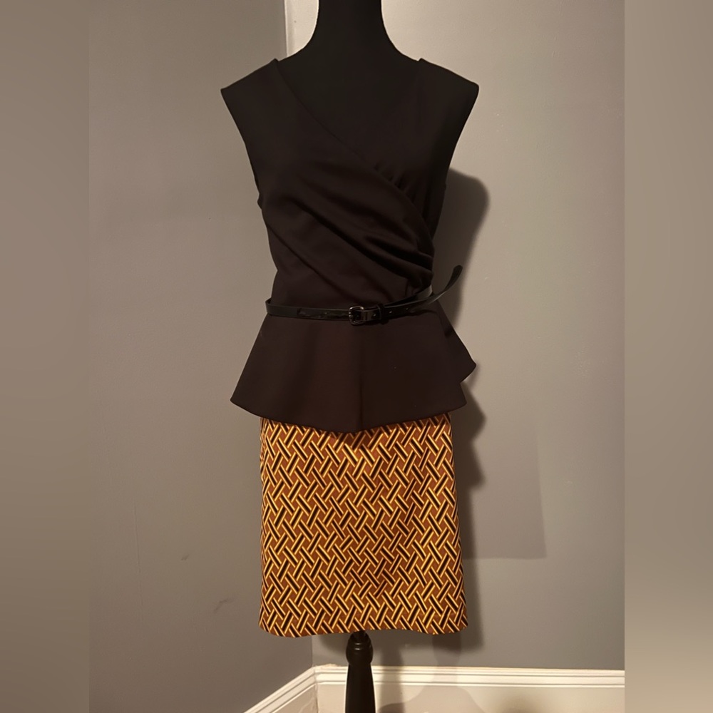 Skirtset; sleeveless top with flare and belt at waist,knee length fitted skirt.